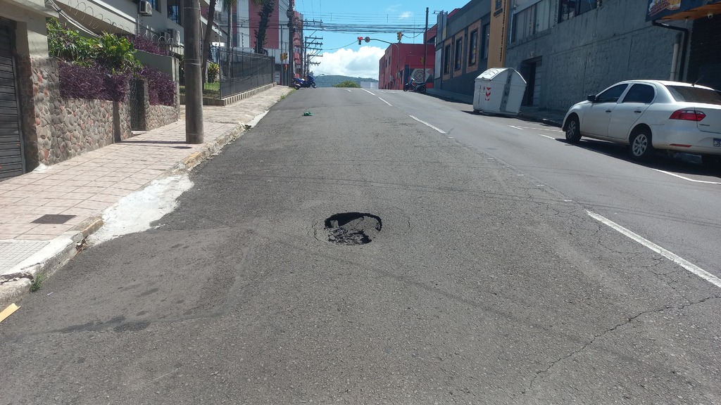 Buraco no asfalto em rua central de Santa Maria tem placas de sinalização furtadas; veja previsão para reparo